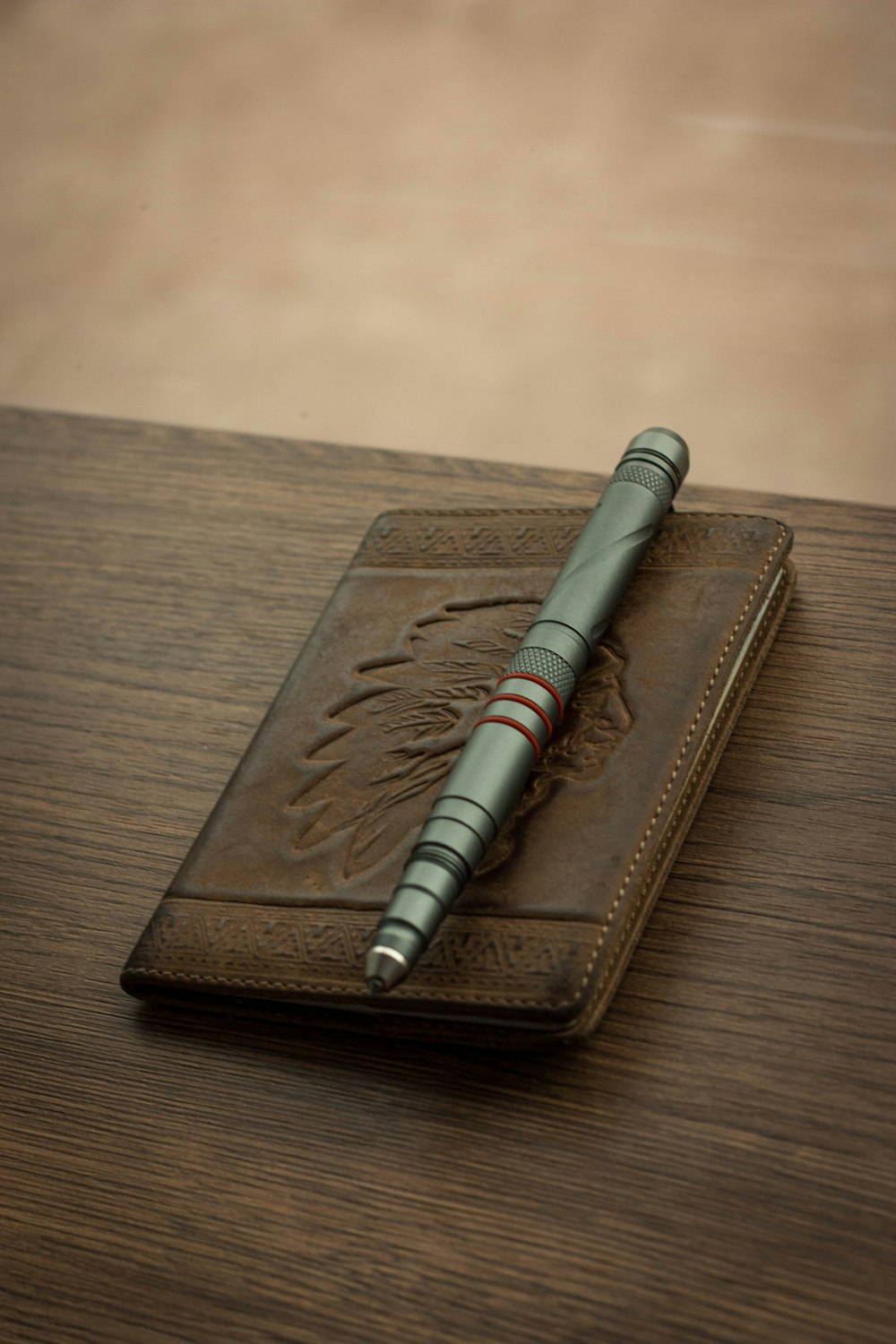 silver pen on brown leather book