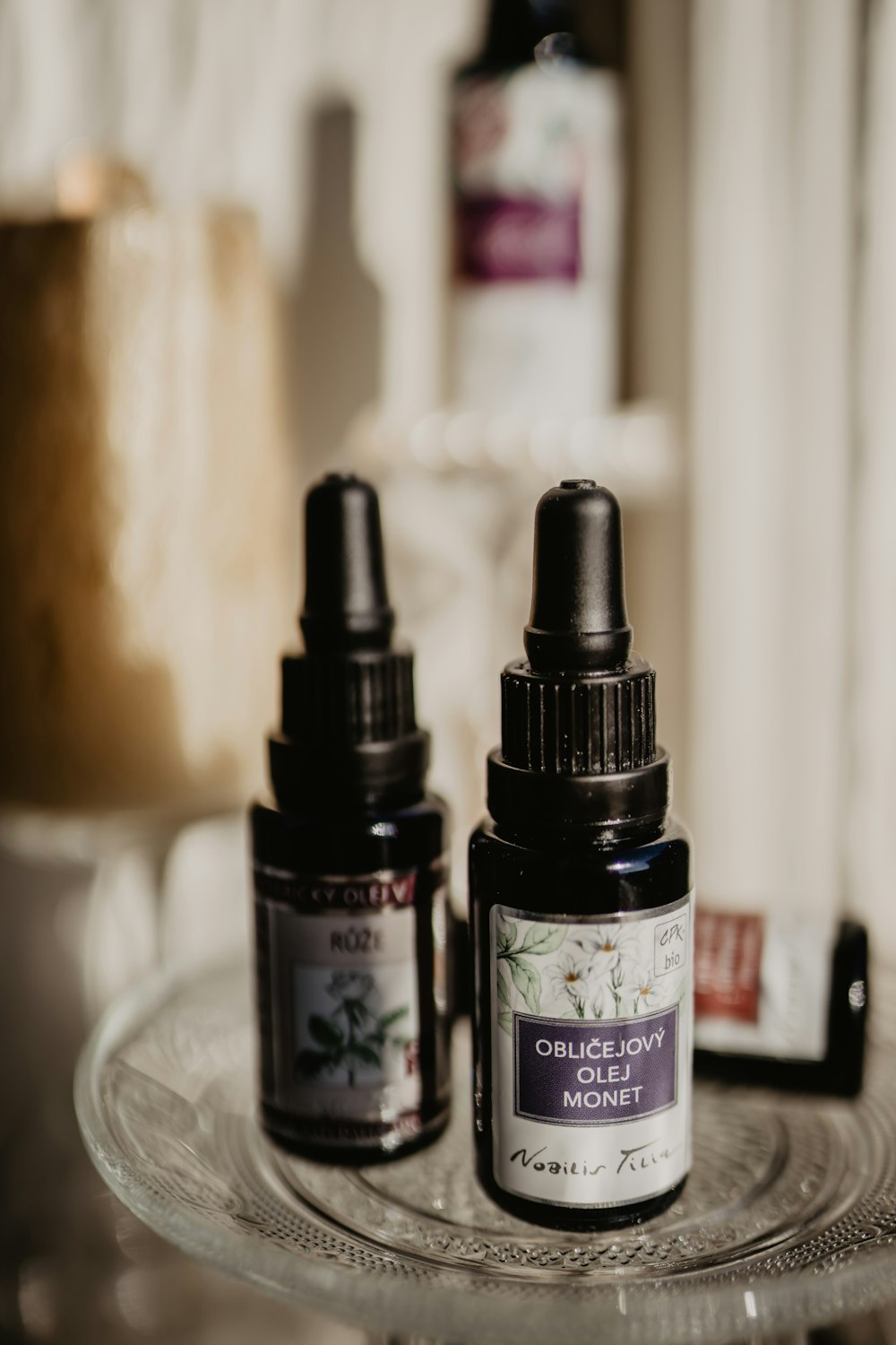 3 black glass bottles on white table