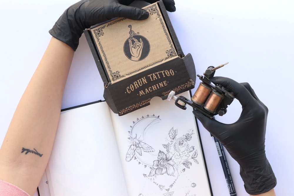 person holding brown and black box