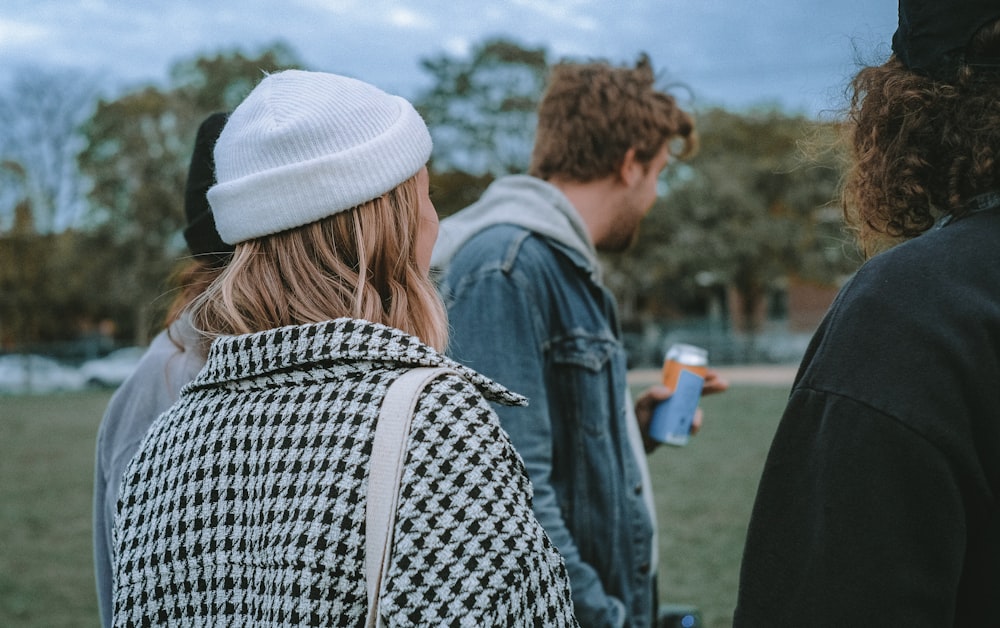 woman in black and white knit cap and blue denim jacket