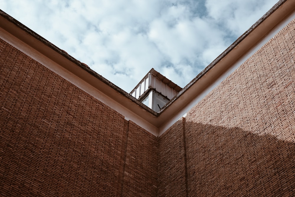 brown brick wall under blue sky during daytime