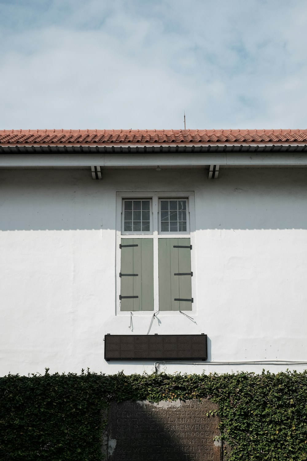 white concrete house with brown roof