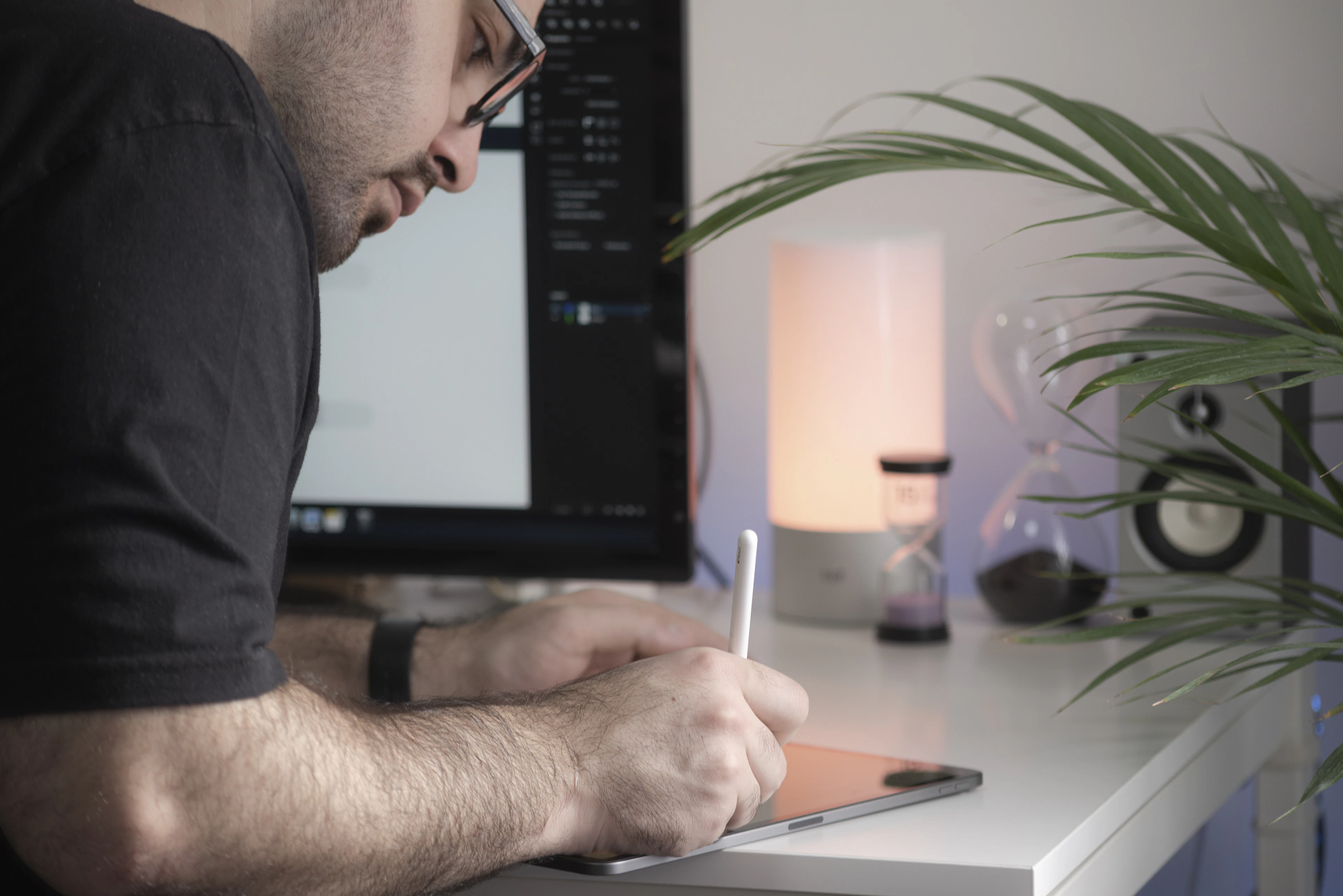 A person sketching notes on paper at a desk
