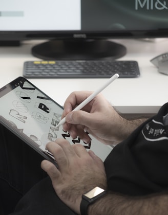 person in black jacket holding white printer paper