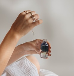 person holding black glass bottle