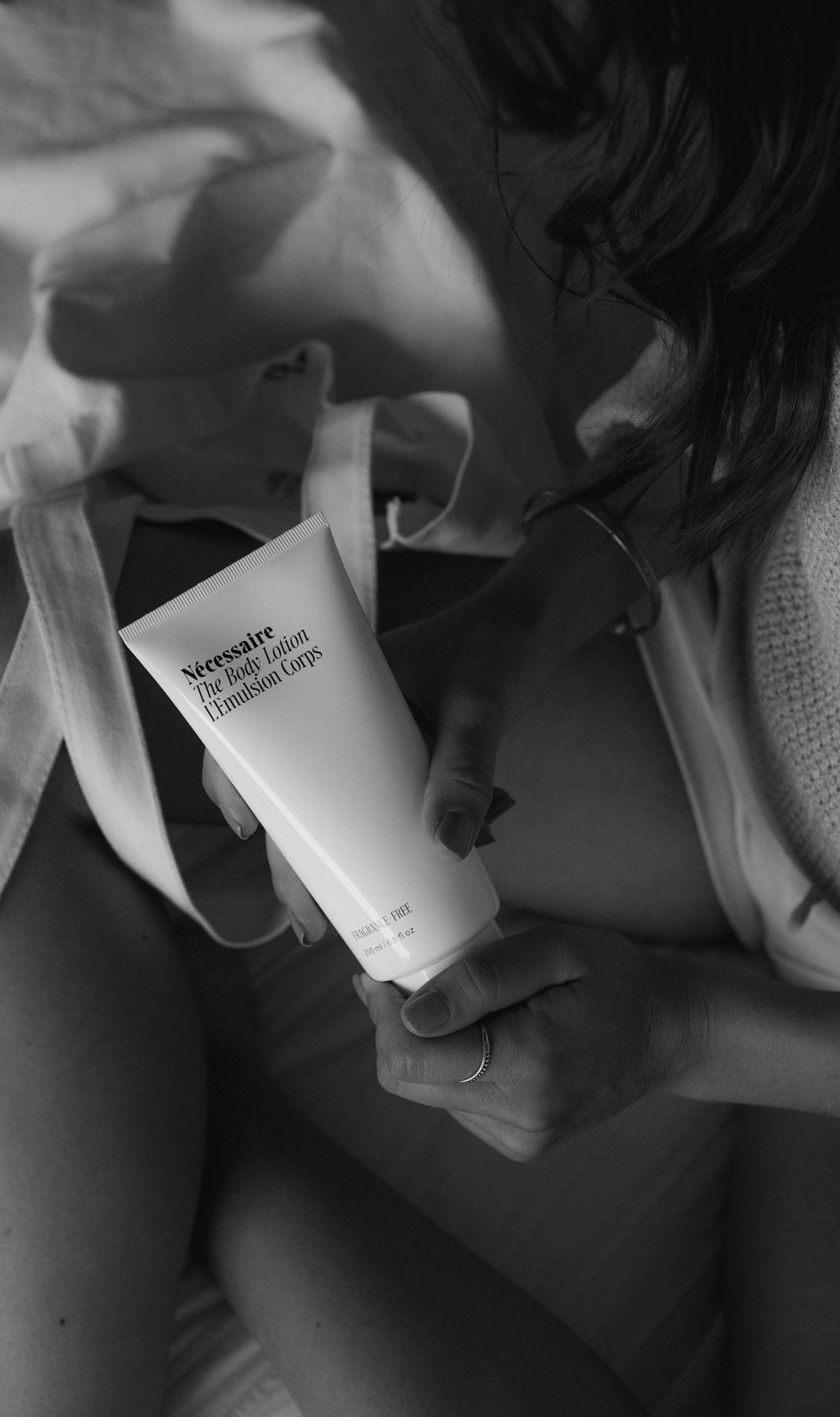 grayscale photo of woman holding white book