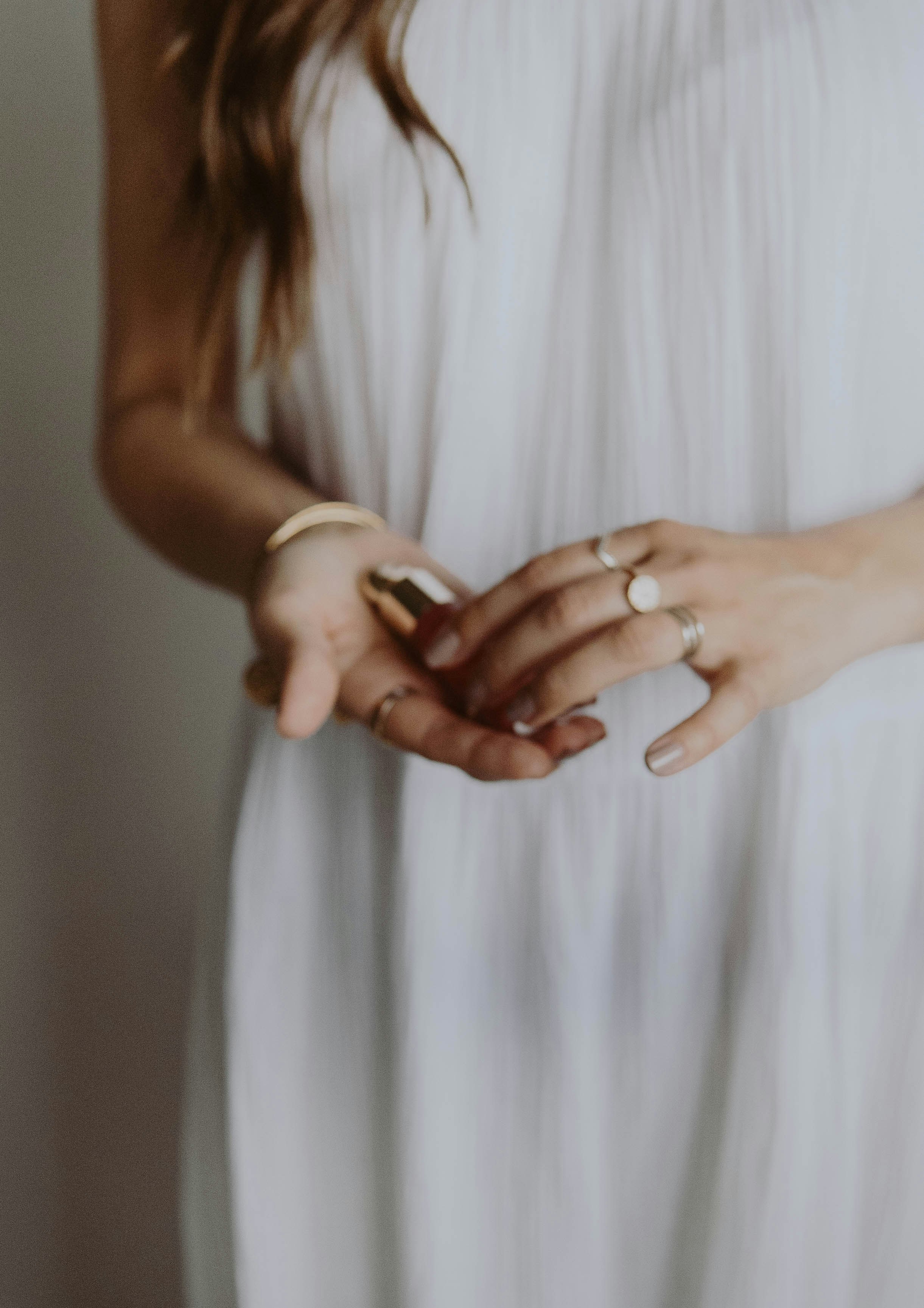 woman in white dress holding her hand