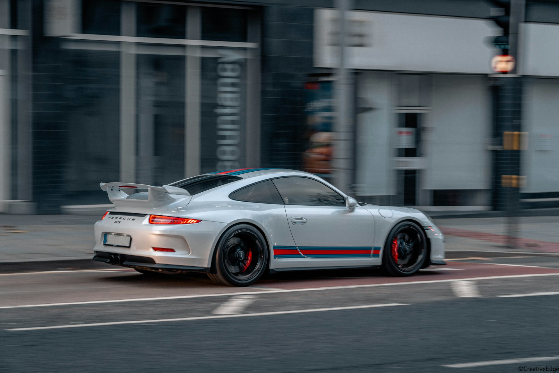 white and red porsche 911 on road during daytime