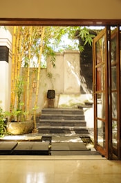 A serene courtyard featuring natural stone paths and subtle water drainage channels.