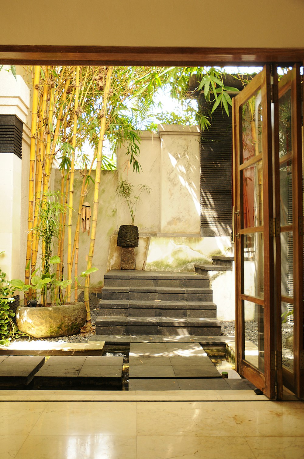 brown wooden staircase near green plants