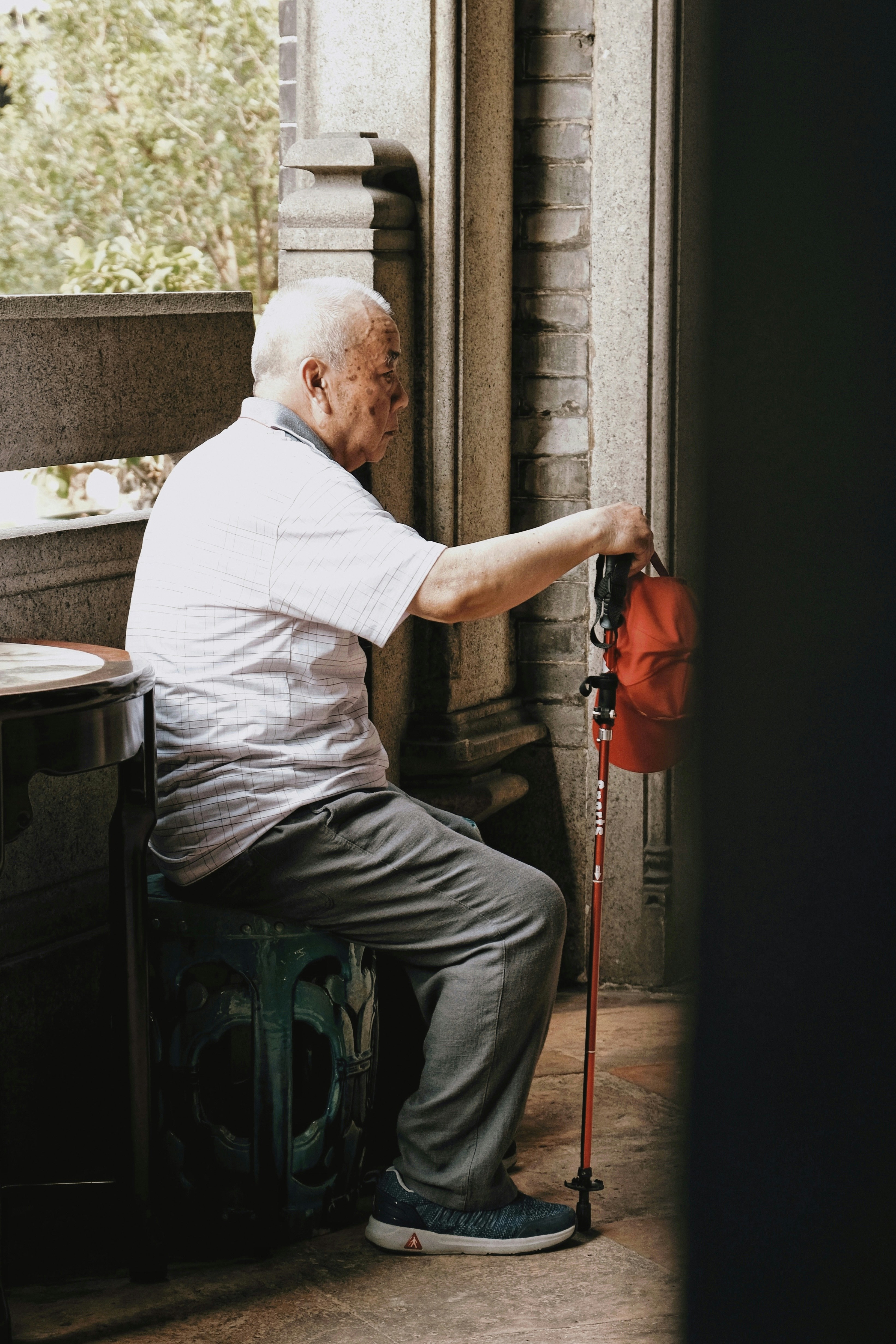 man in white shirt and black pants holding red and black power tool