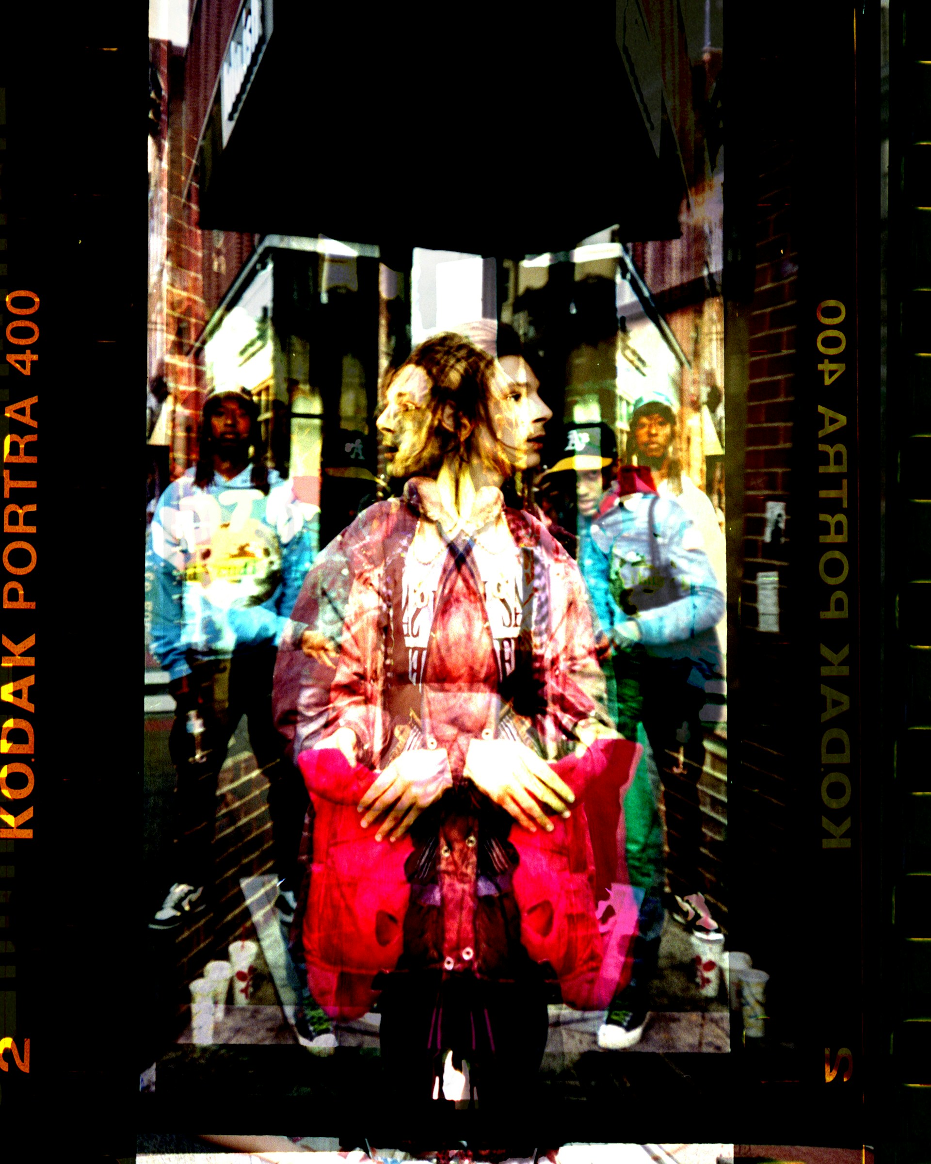 A candid street portrait showing a thoughtful expression beneath a city’s bustling backdrop, glowing with natural light.