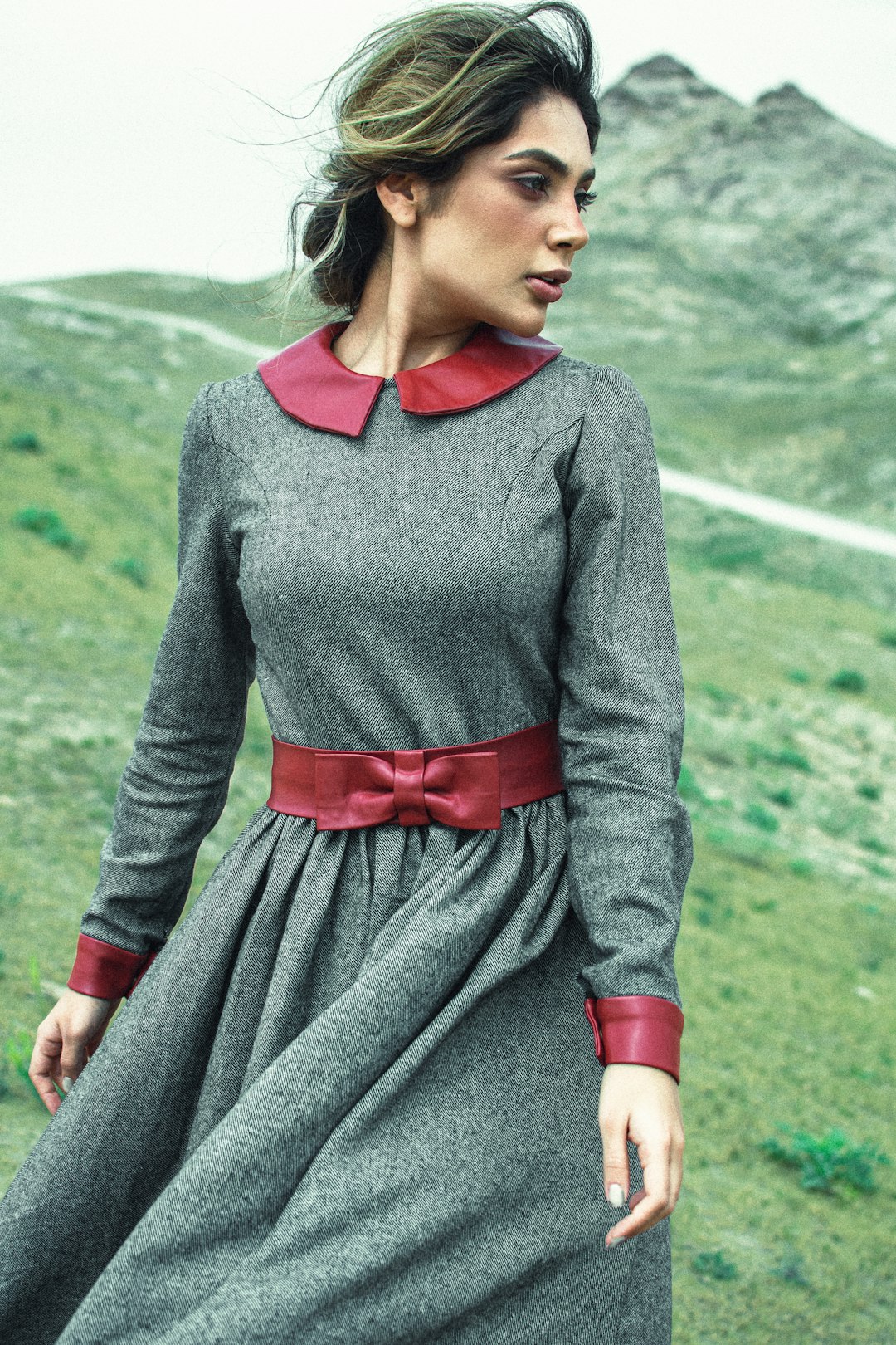 woman in gray long sleeve shirt and red skirt