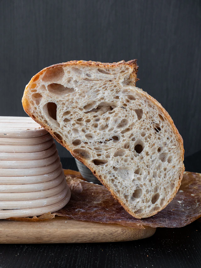 A torn loaf of sourdough on a board
