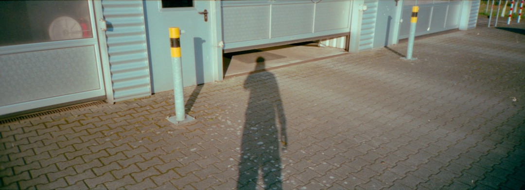 person in gray pants standing near white wooden door