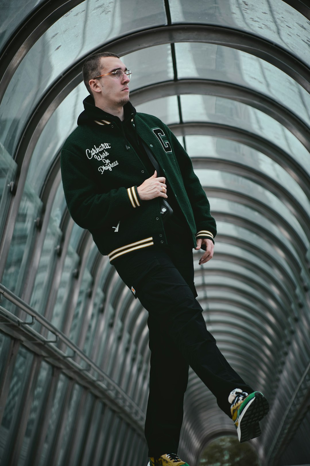 man in black jacket standing on escalator