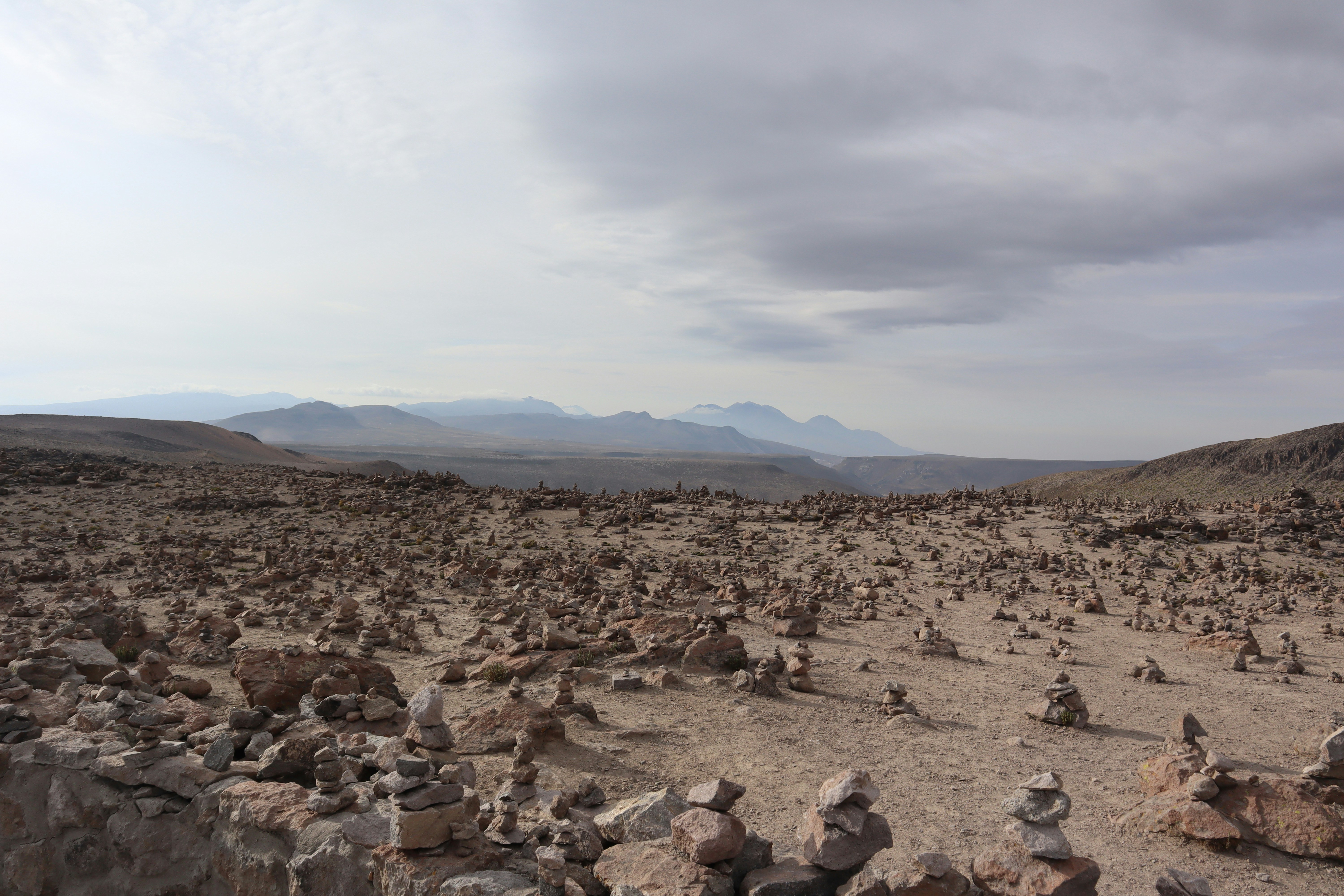 people sitting on rock formation during daytime, 