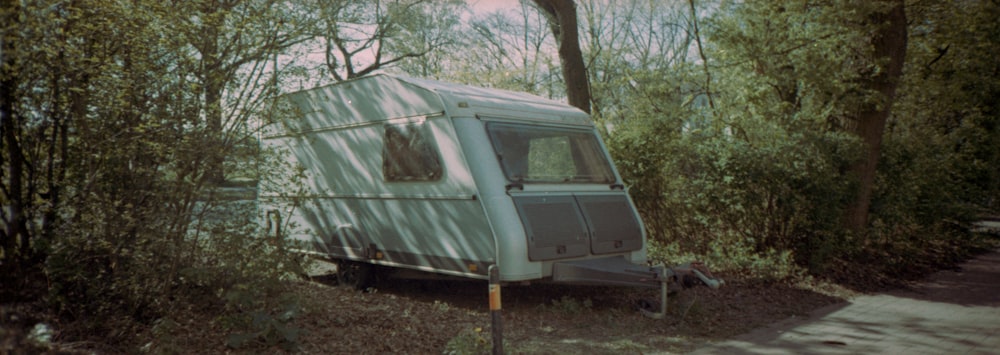 white and green camper trailer