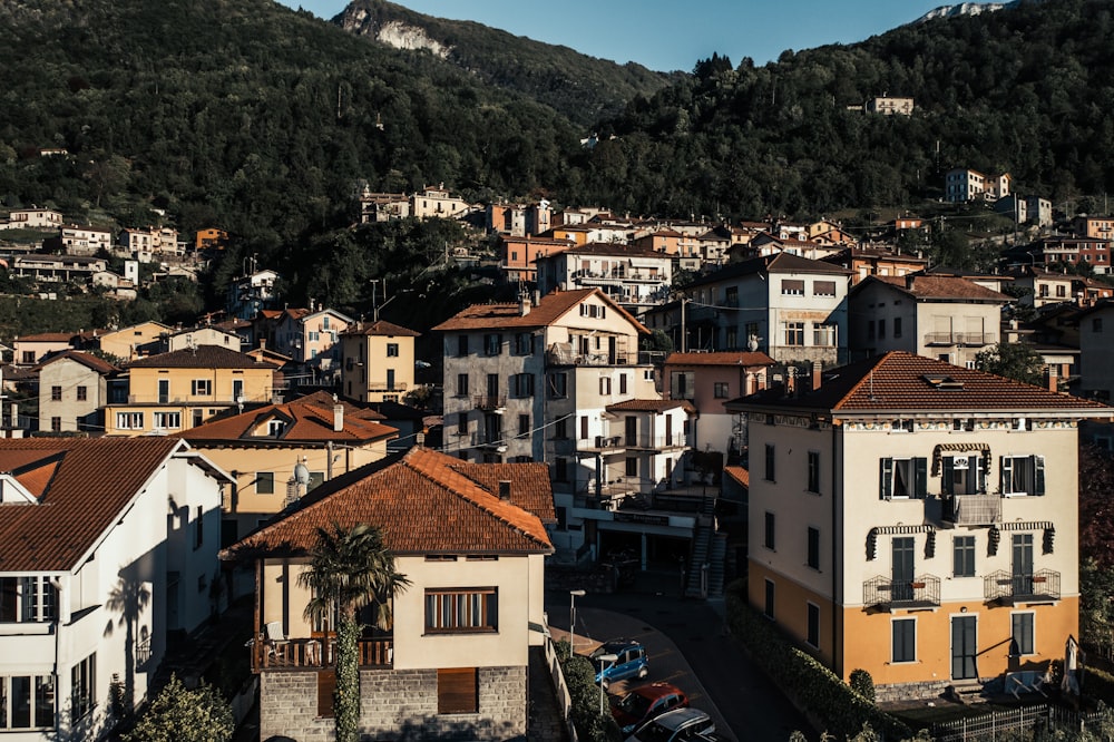 white and brown concrete buildings near mountain during daytime