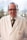 man in white coat wearing black framed eyeglasses