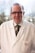 man in white coat wearing black framed eyeglasses