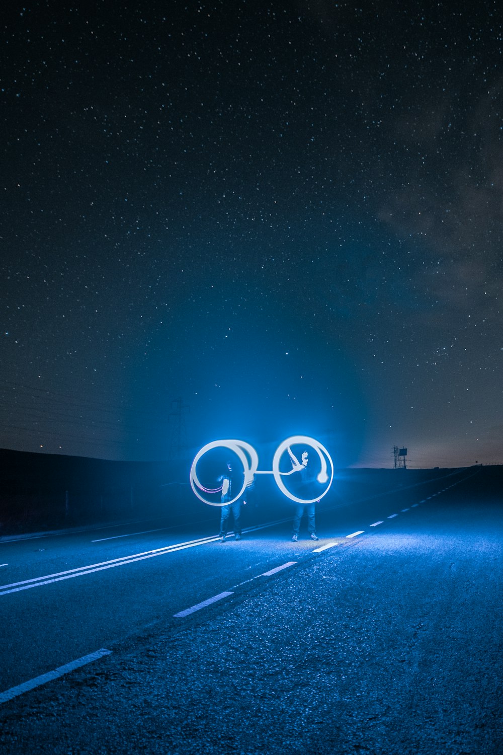 blue light in the middle of the road during night time