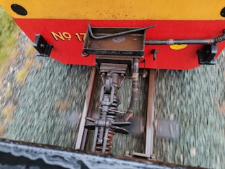 A set of couplers displayed against a backdrop of rail tracks.