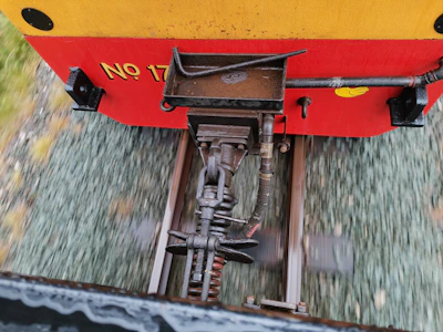 Industrial cooperation scene showing handshake between two professionals near rail infrastructure.