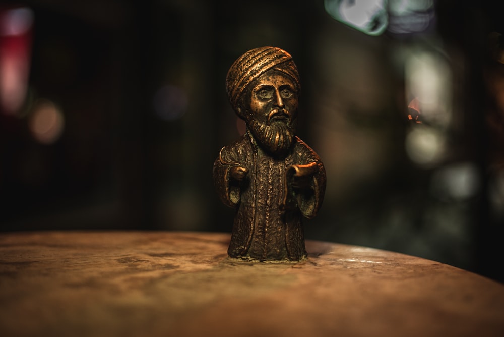 brown wooden man figurine on brown wooden table