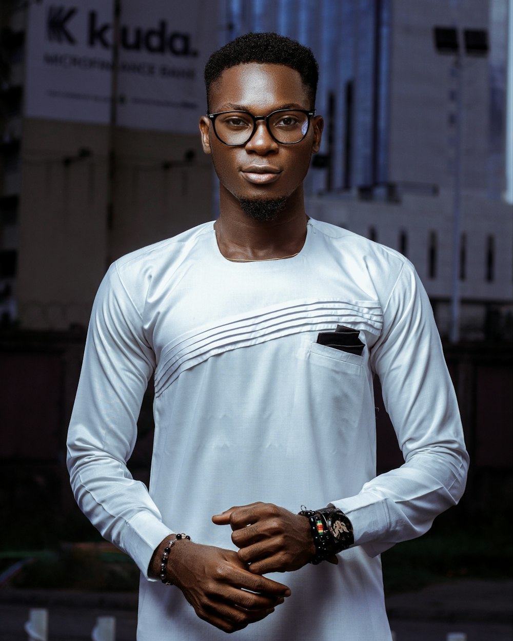 man in white long sleeve shirt wearing black framed eyeglasses