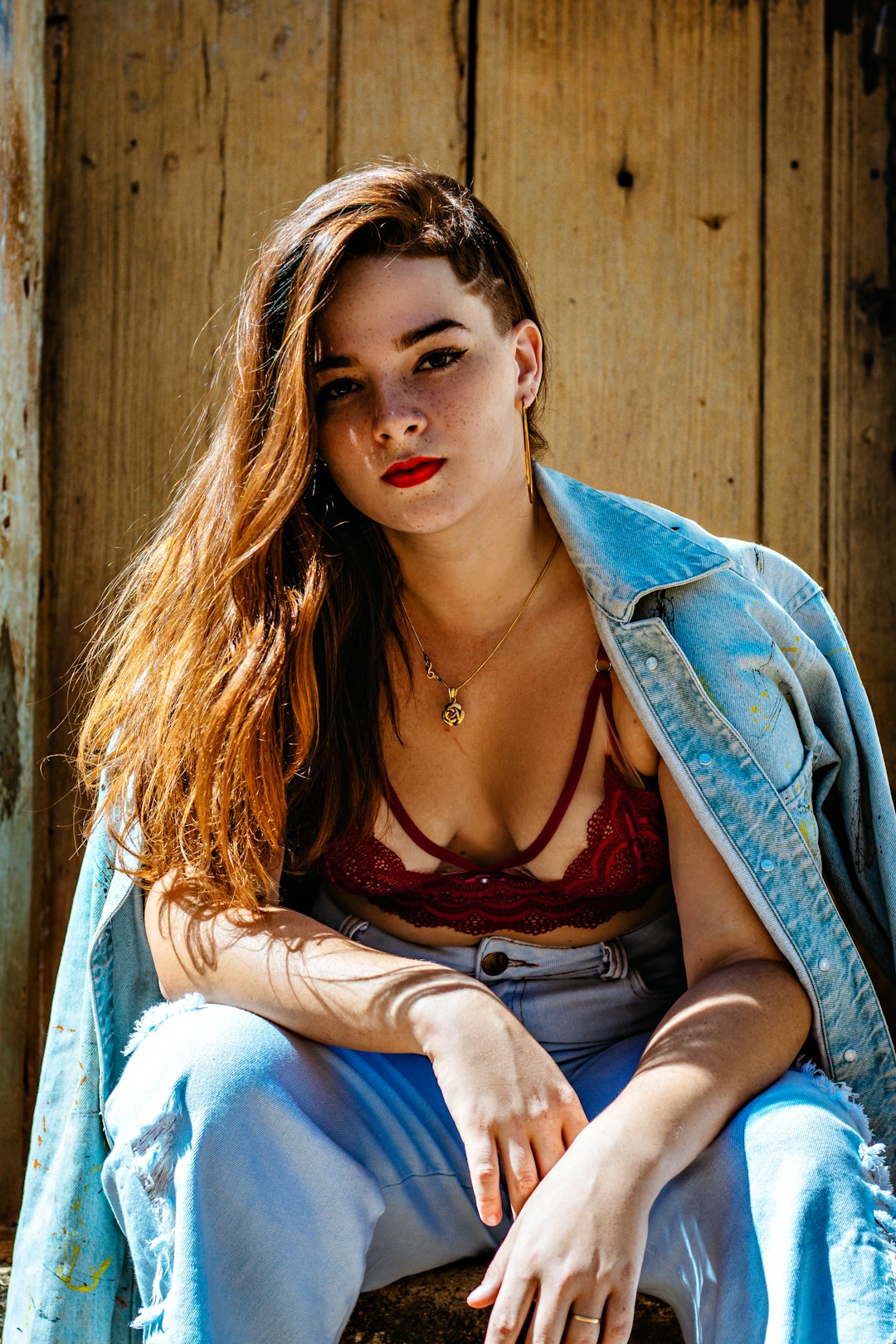 woman in blue denim jacket and red tank top