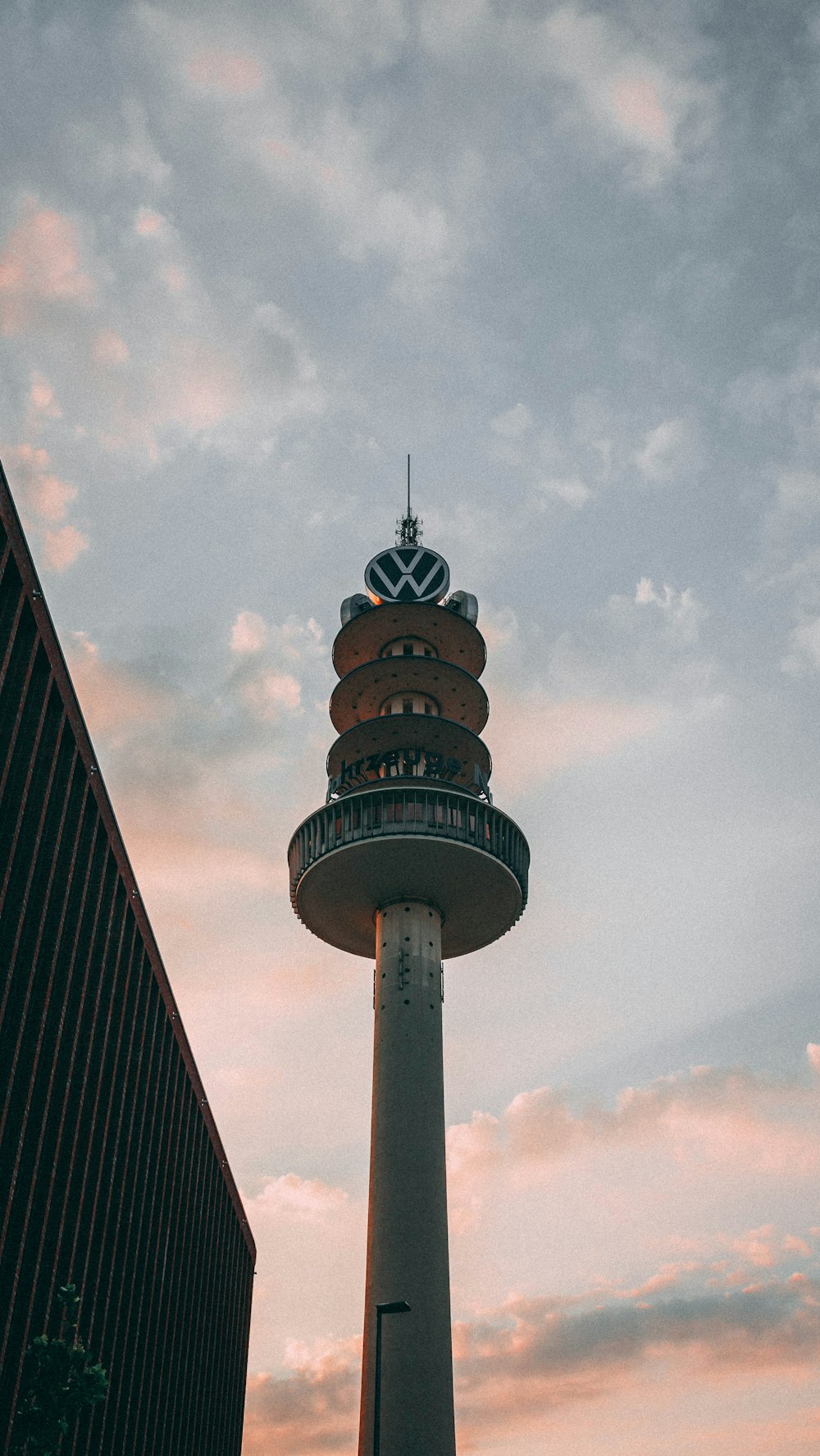 brown and white tower under cloudy sky