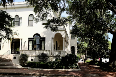 Front facade of a cozy sober living house featuring large windows and a bright entrance.