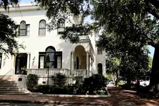 Front facade of a cozy sober living house featuring large windows and a bright entrance.