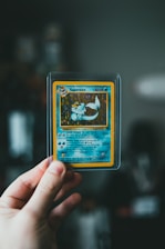 pokemon trading card on persons hand
