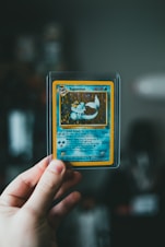 pokemon trading card on persons hand