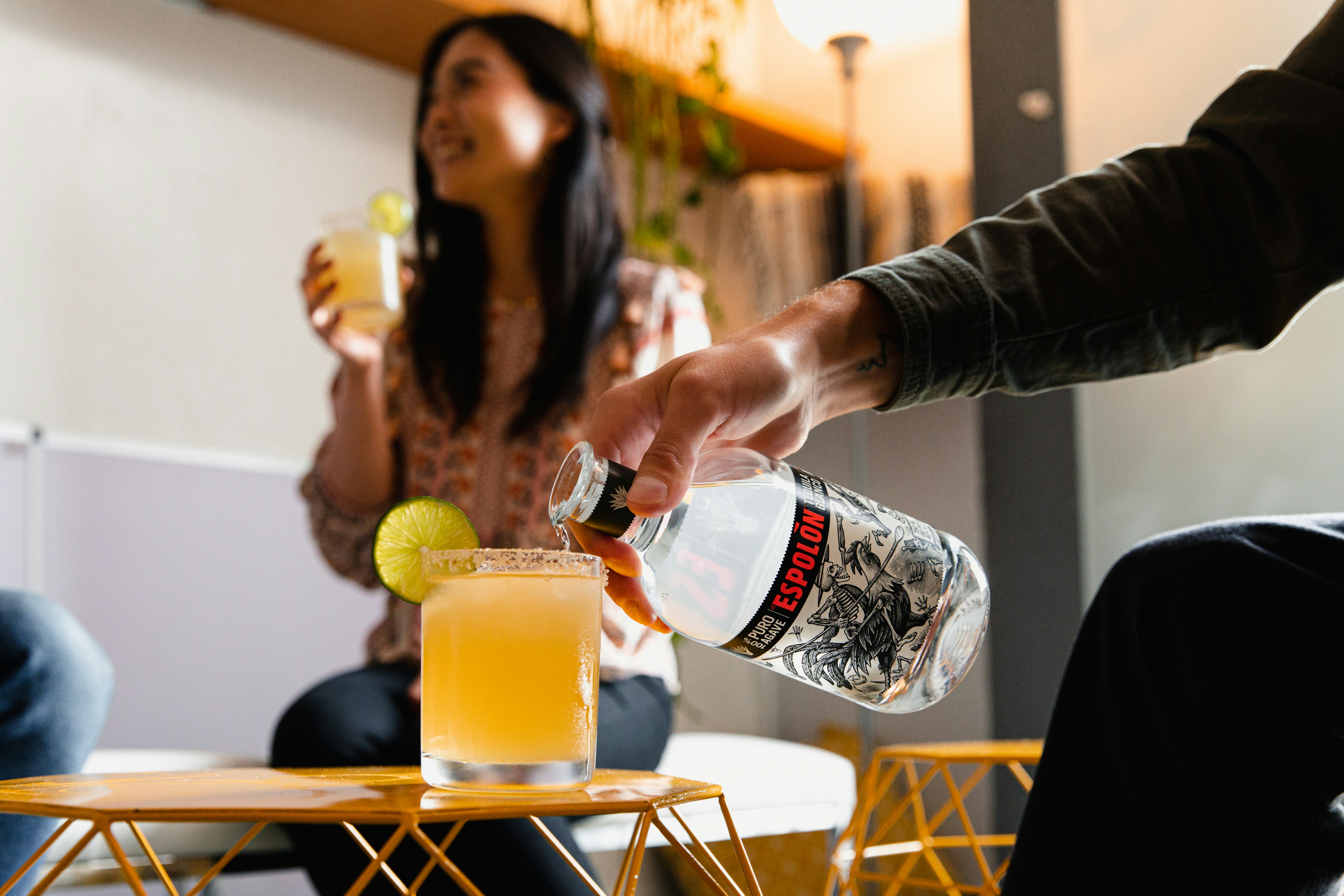 woman in black long sleeve shirt holding clear plastic bottle