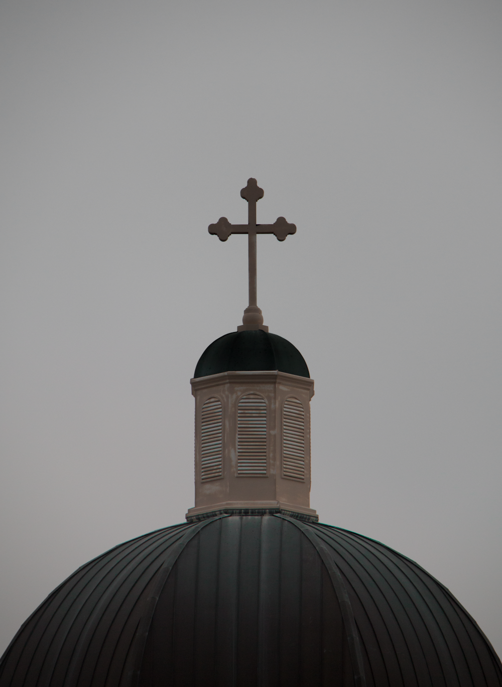 brown cross on top of black textile