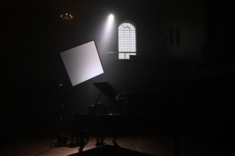 black grand piano with white light fixture