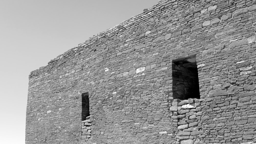 grayscale photo of brick wall