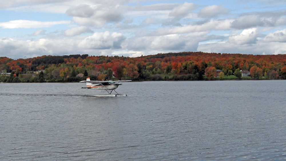 white boat on body of water during daytime