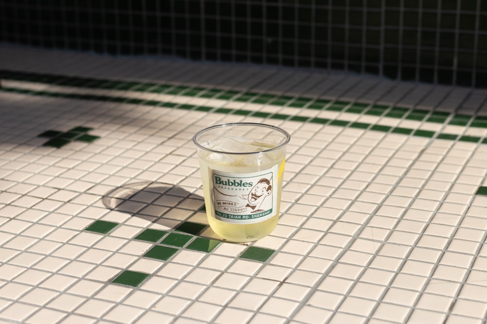 clear glass cup on white and black checkered table