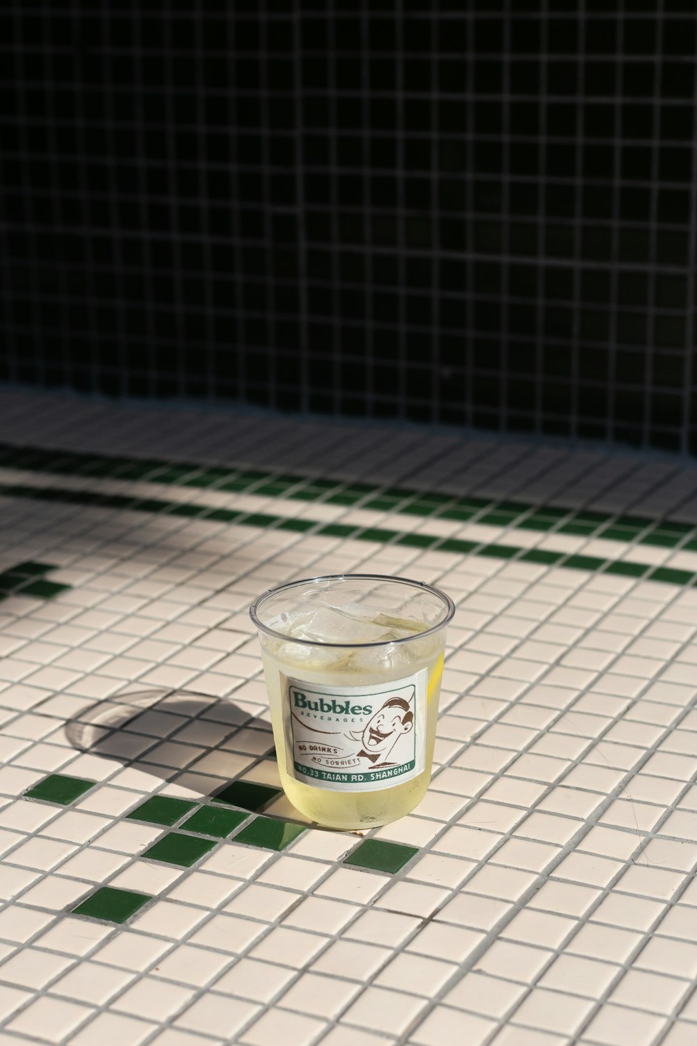 clear glass cup on white and black checkered table