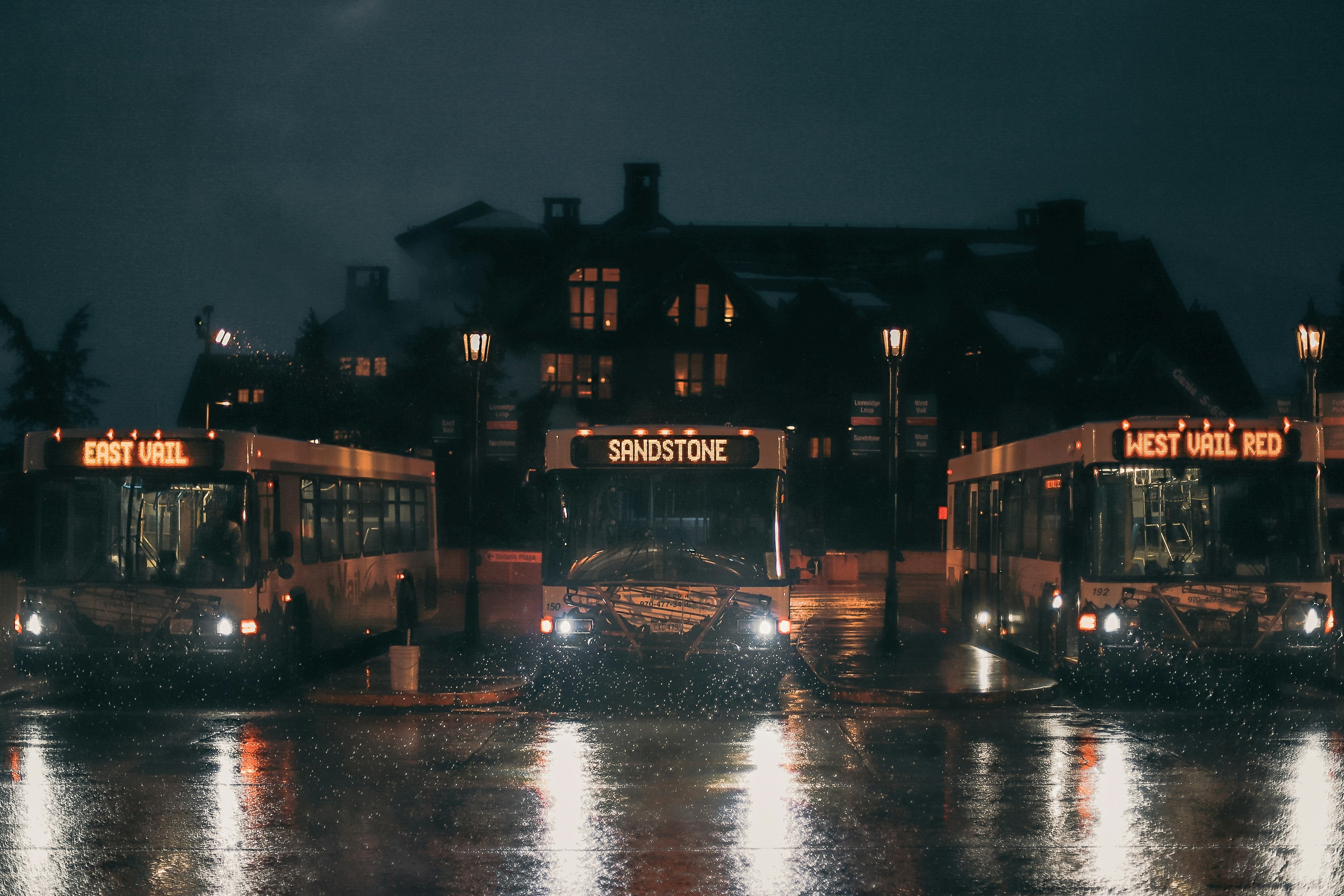 black and brown concrete building near body of water during night time