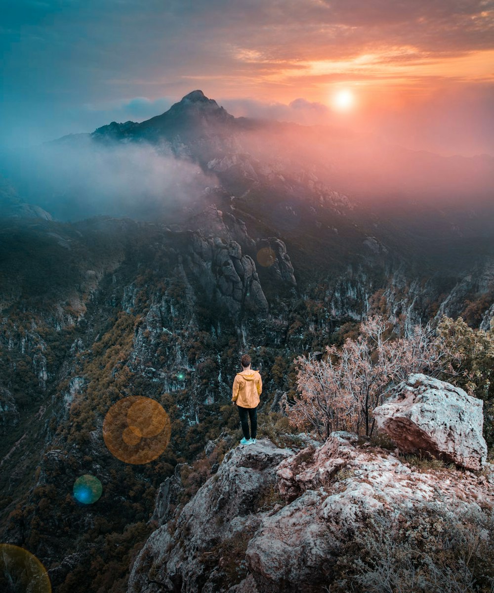 person standing on rock formation during daytime