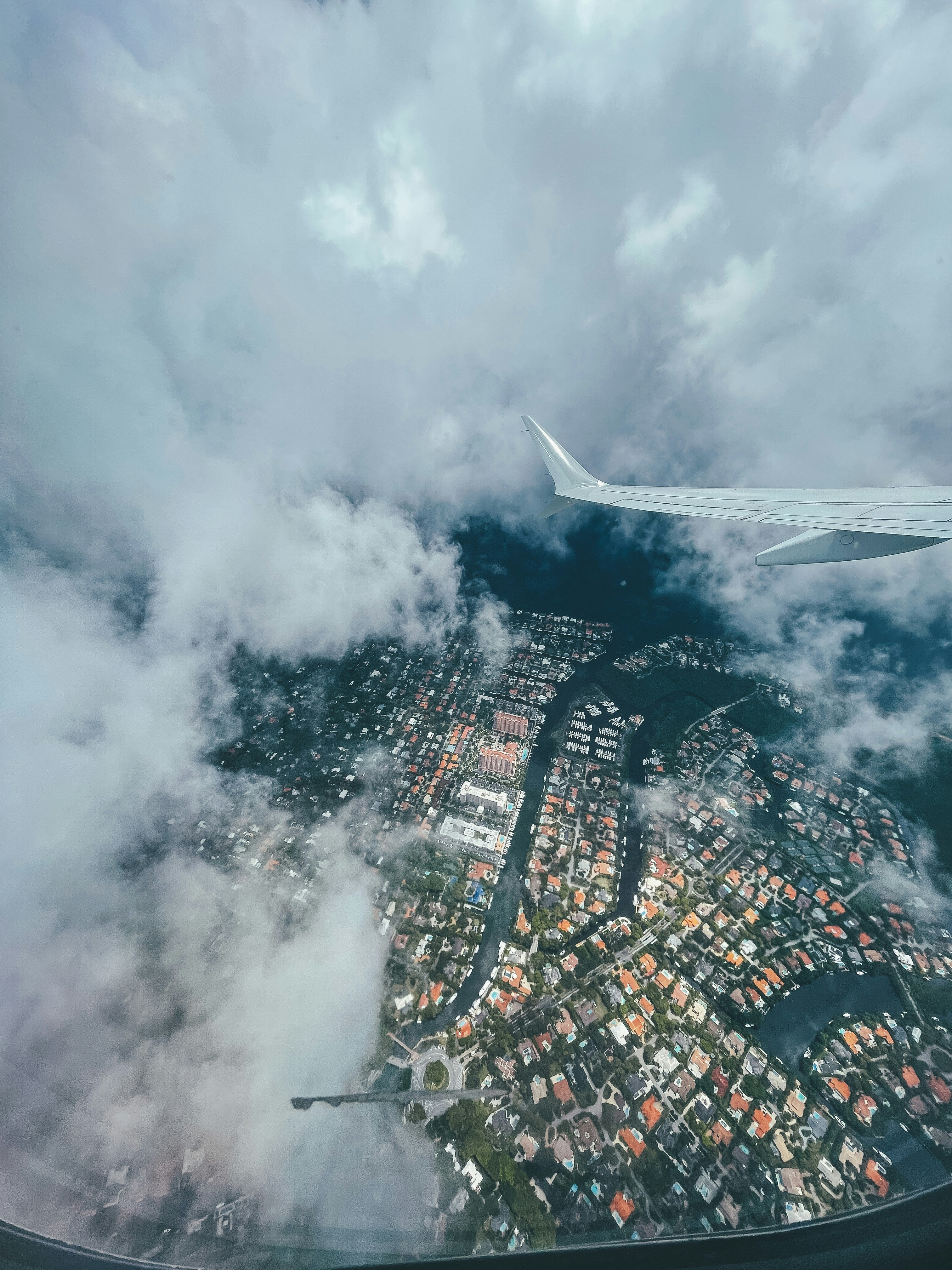 aerial view of city buildings under cloudy sky during daytime