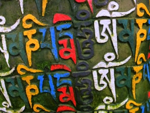 Close-up of a hand-painted Tibetan thangka with vibrant mineral colors.