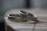silver ring on brown wooden table