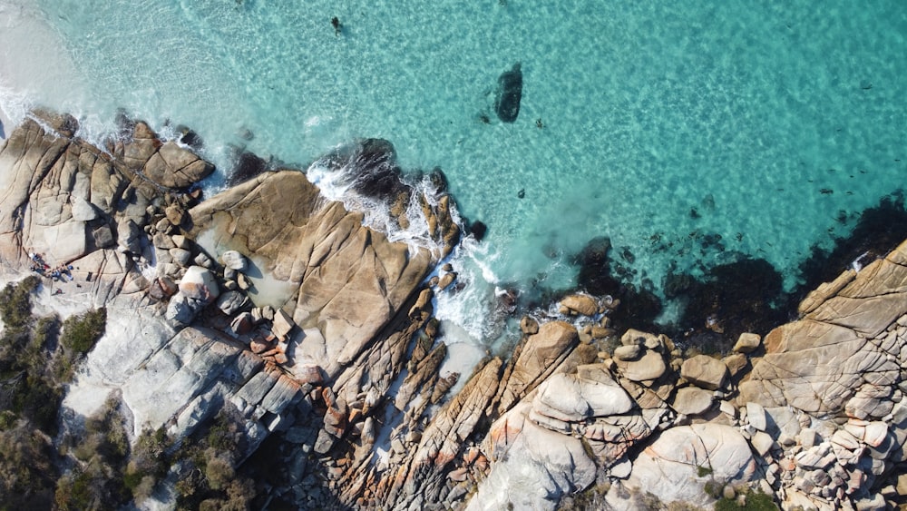 brown rock formation on blue sea during daytime