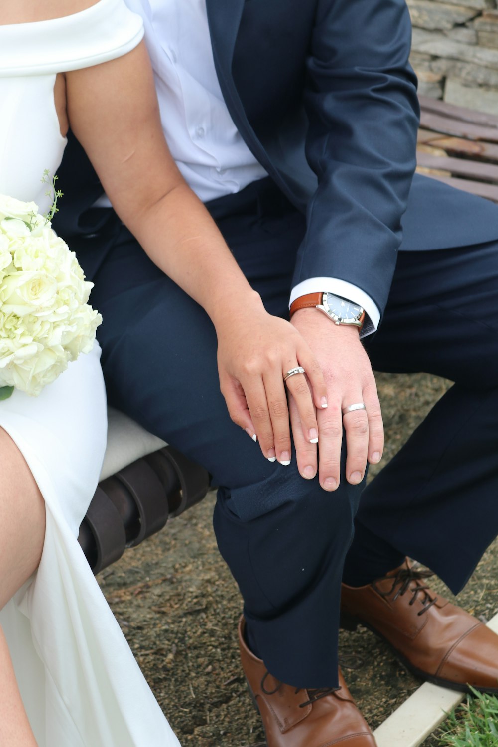 man in blue suit jacket and woman in white dress